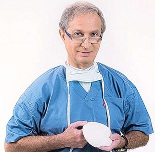 the doctor holds an implant for breast augmentation